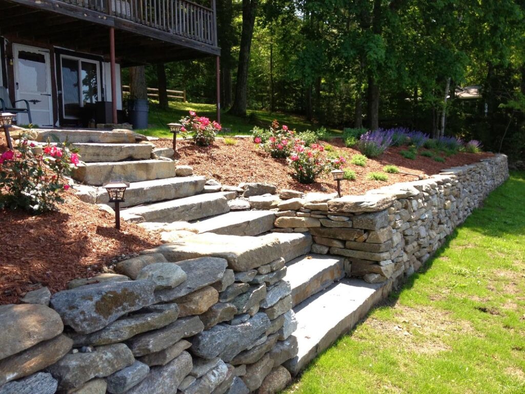 Beautiful stone retaining wall with steps and garden landscaping design.